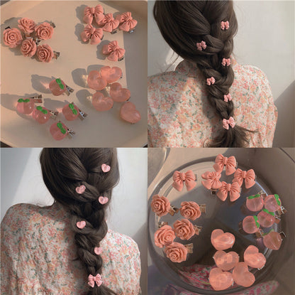 粉色蝴蝶結山茶花髮夾－商品主圖｜https://igowo.tw/